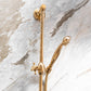 The Francone BTS21 unlacquered brass sliding rail handheld shower mounted on a marble wall.