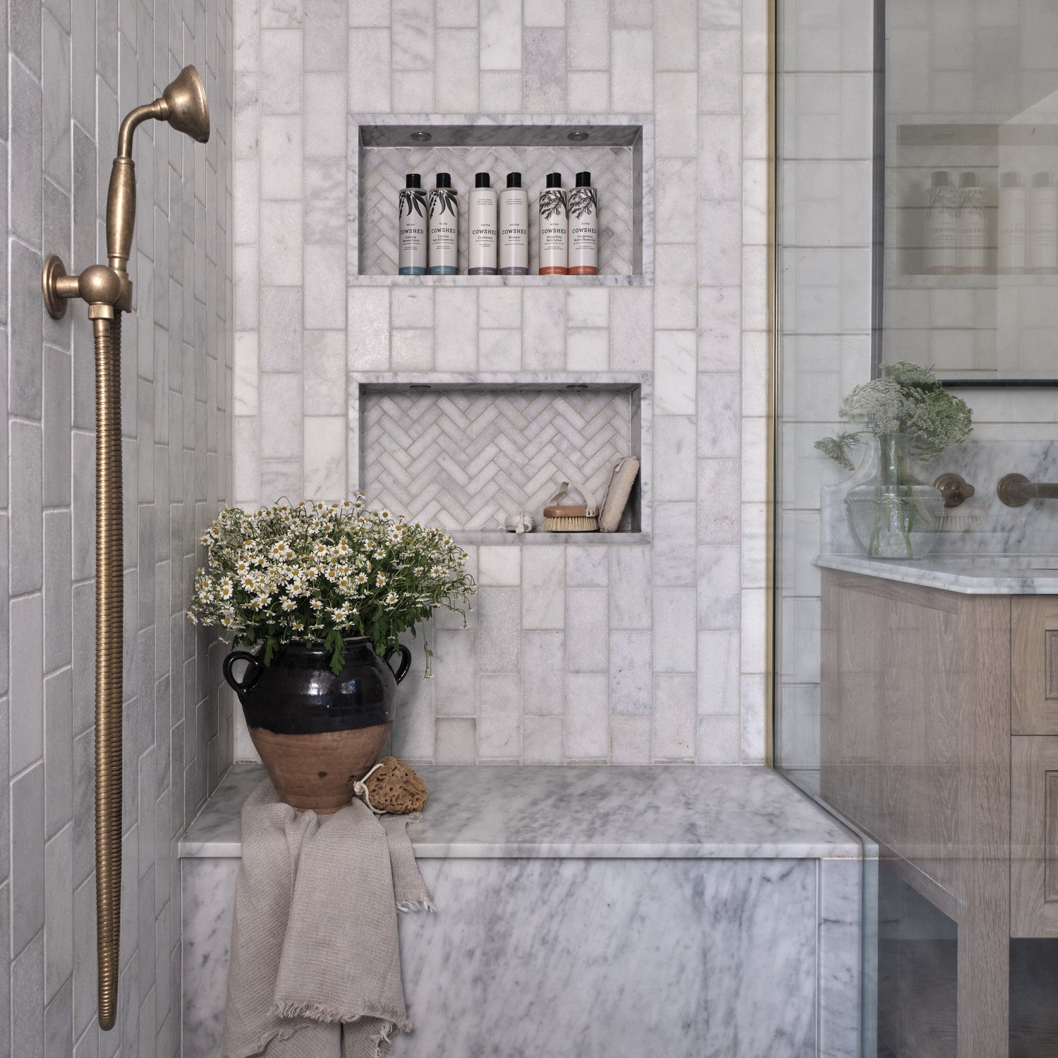 Traditional Francone BTS23 wall-mounted solid brass hand shower with living patina, installed in a marble bathroom by Millie Turner, photo by Sarah Griggs.