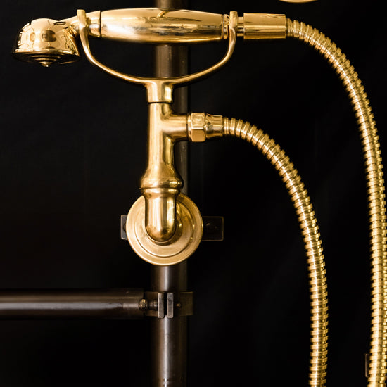 Detail of the Francone BTS26 traditional unlacquered brass hand shower with holder.
