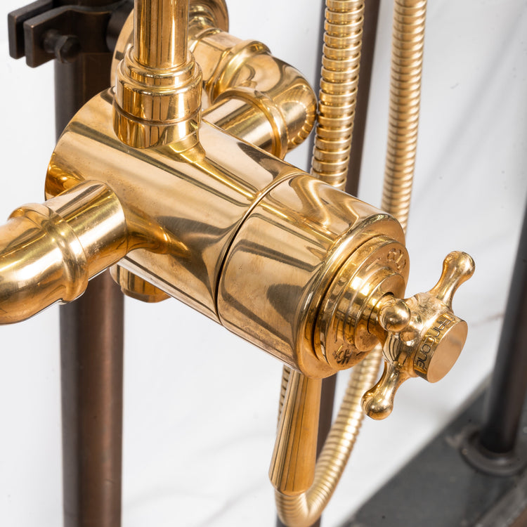 A close-up detail of the traditional Francone BTS26T thermostatic hand shower in solid unlacquered brass.