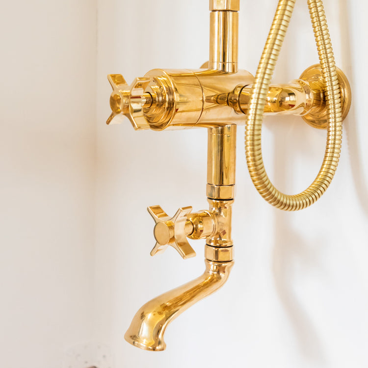 Detail of the gold plated brass Francone BTS3 thermostatic column shower and bath filler with crosshead handles.