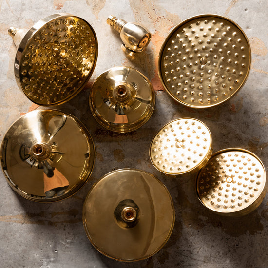 An array of Francone BTS35 classic circular solid brass shower head options in unlacquered brass.
