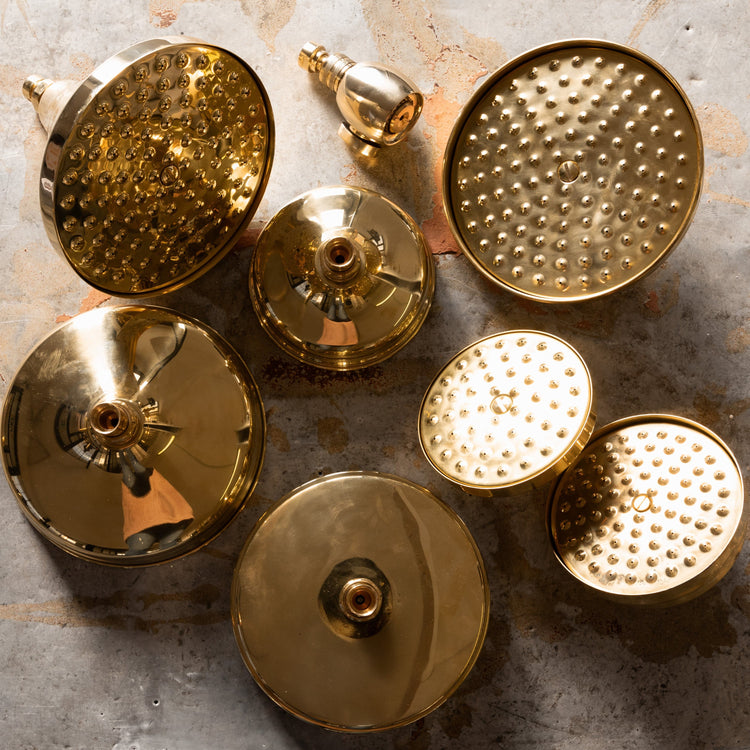 An array of Francone BTS35 classic circular solid brass shower head options in unlacquered brass.