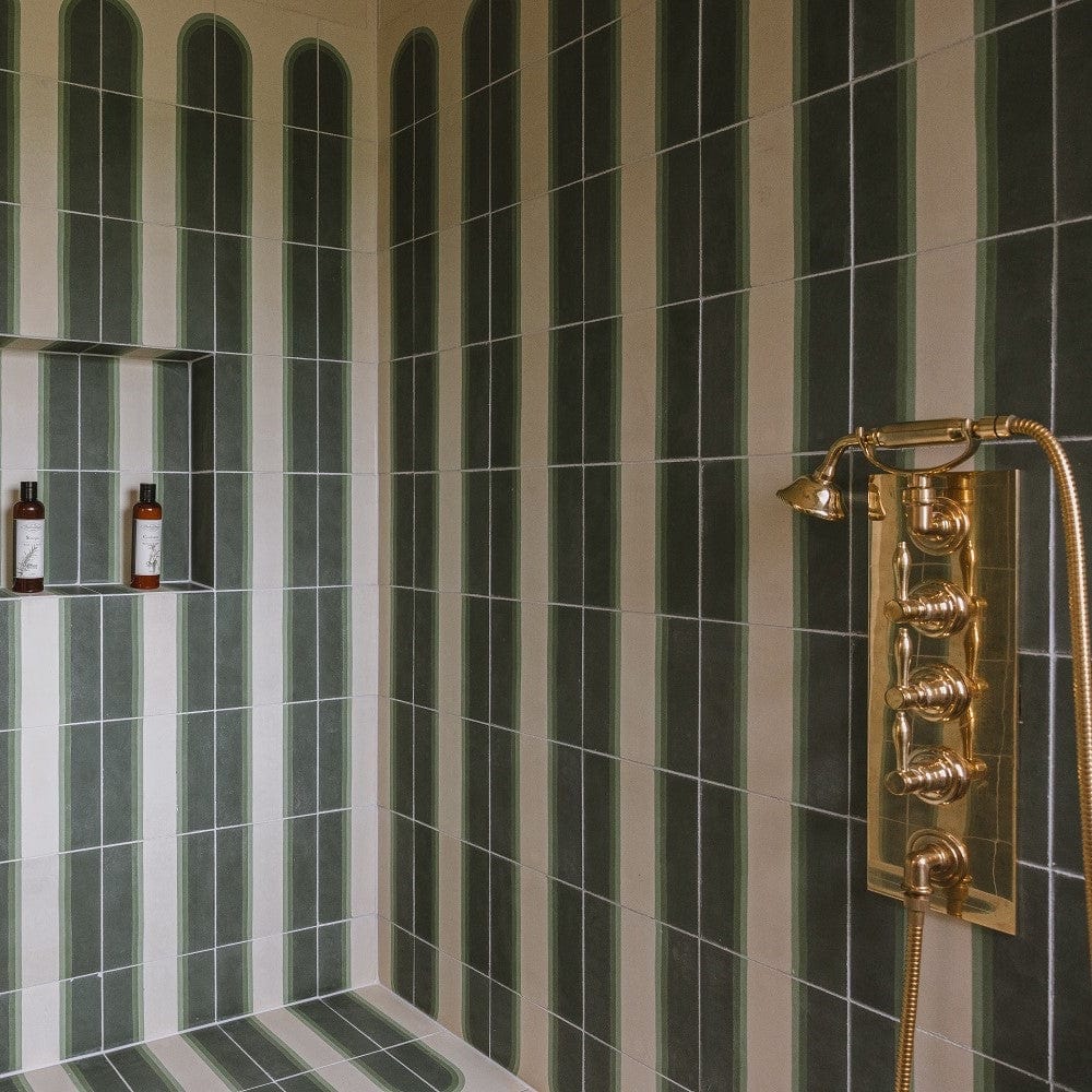 Francone BTS40 traditional brass thermostatic shower control valve installed in a green-striped tiled shower.