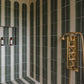 Francone BTS40 traditional brass thermostatic shower control valve installed in a green-striped tiled shower.