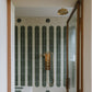 The Francone BTS40 unlacquered brass thermostatic shower with hand shower installed in a tiled bathroom.