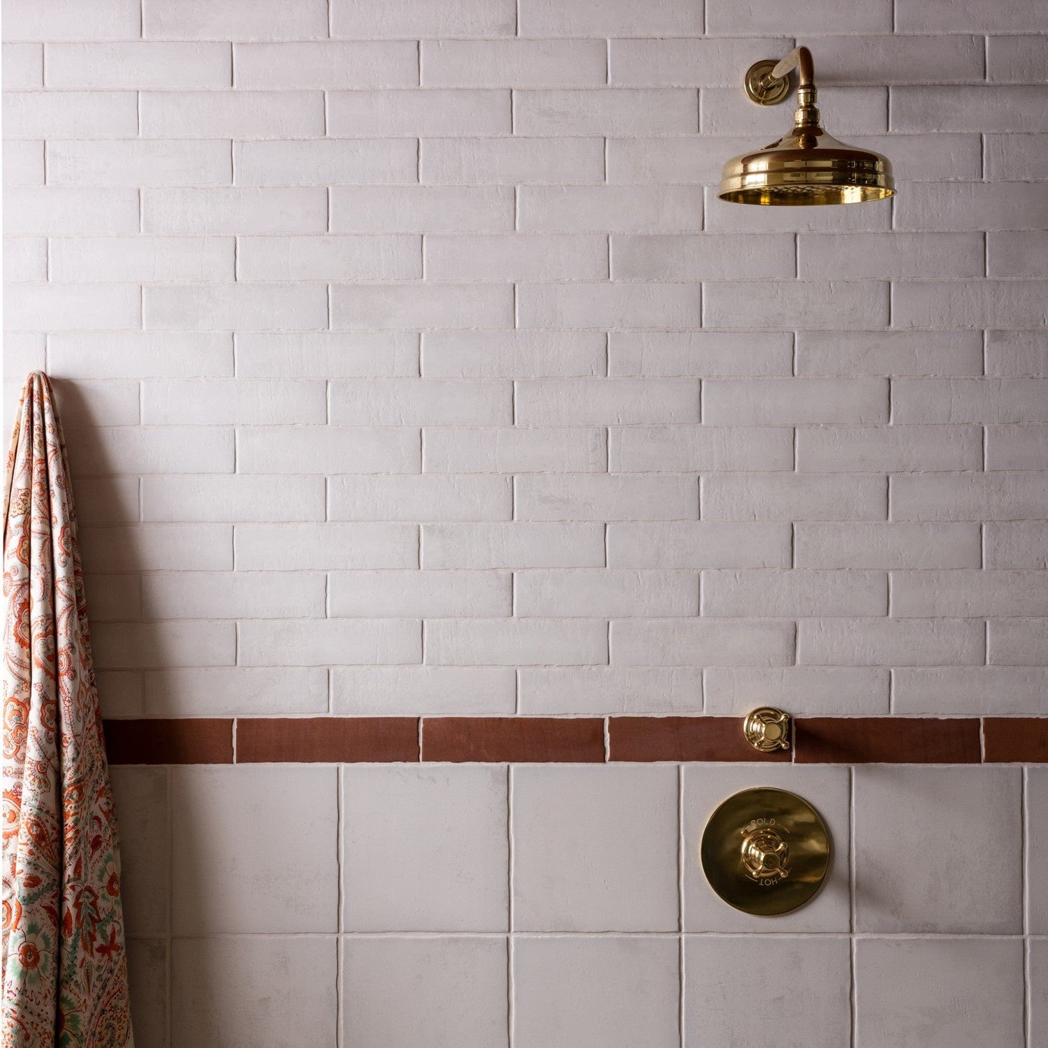 Francone BTS41 unlacquered brass concealed thermostatic shower control installed on a tiled wall.