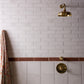 Francone BTS41 unlacquered brass concealed thermostatic shower control installed on a tiled wall.