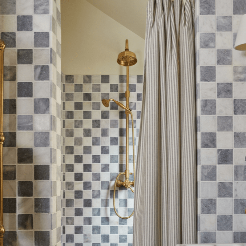 Traditional Francone BTS42 unlacquered brass exposed thermostatic column shower installed in a tiled bathroom.