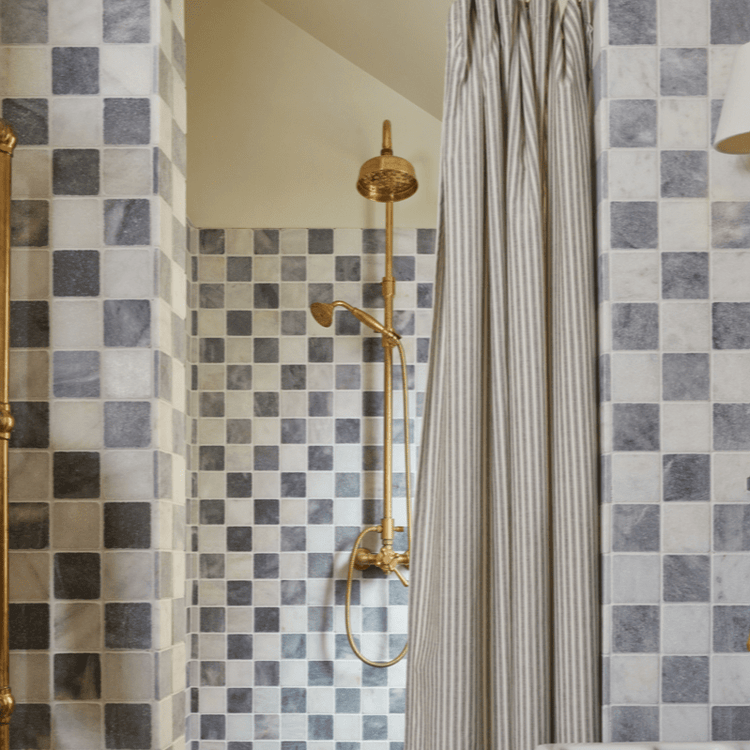 Traditional Francone BTS42 unlacquered brass exposed thermostatic column shower installed in a tiled bathroom.