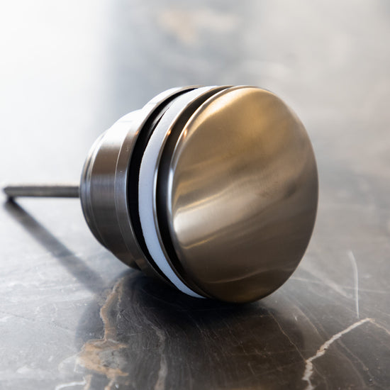 A close-up detail of the Francone SSA4 solid brass circular click clack basin waste.