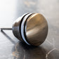 A close-up detail of the Francone SSA4 solid brass circular click clack basin waste.