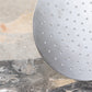 Detail of the handcrafted solid brass Francone SSS17 circular shower head in a luxury bathroom.