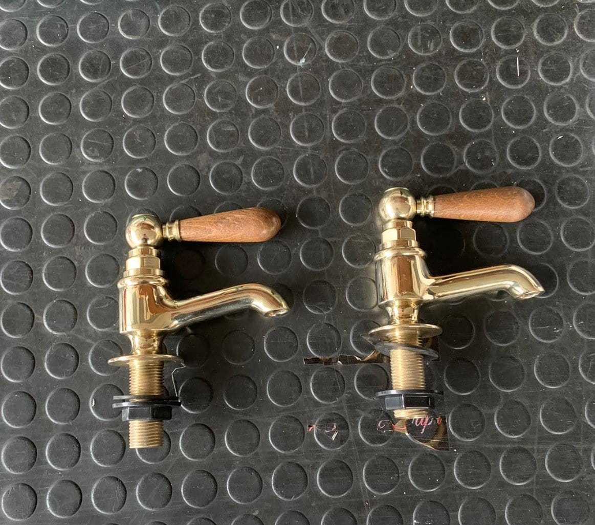Traditional Francone BT15W unlacquered brass bathroom pillar taps, also known as faucets, with wooden lever handles.