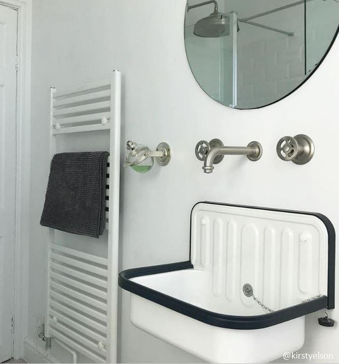 Francone BT20 wall-mounted bathroom faucet with traditional wheel handles, installed above a vintage sink.