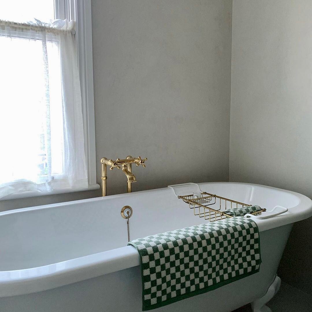 Traditional Francone BT25F solid brass floor mounted bathroom faucet standing beside a clawfoot tub.
