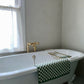 Traditional Francone BT25F solid brass floor mounted bathroom faucet standing beside a clawfoot tub.