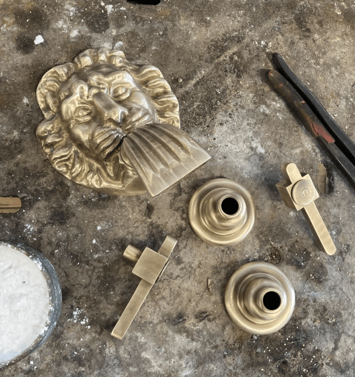 Francone BT39 traditional wall-mounted bathroom faucet with decorative lion head in unlacquered satin brass.