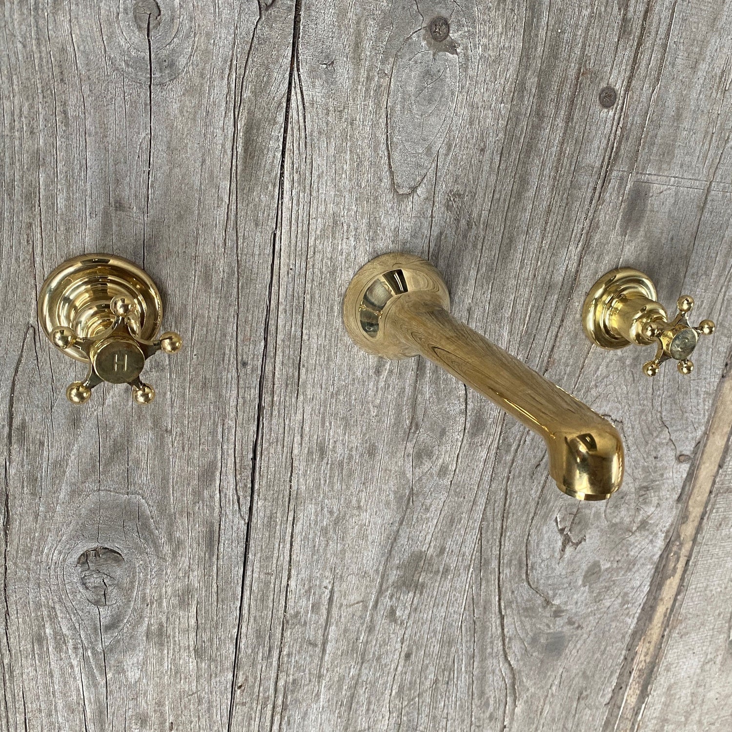 Francone BT91 traditional wall-mounted bathroom faucet with hot and cold handles in unlacquered brass.