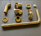 Unassembled components of the Francone BTA10 unlacquered brass bath waste and overflow for exposed bathtubs.