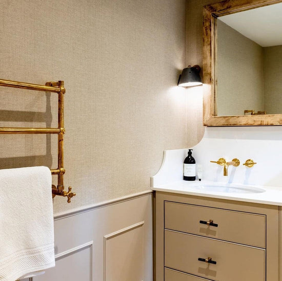The Francone BTR16 unlacquered brass traditional heated towel rail installed in a vintage style bathroom.