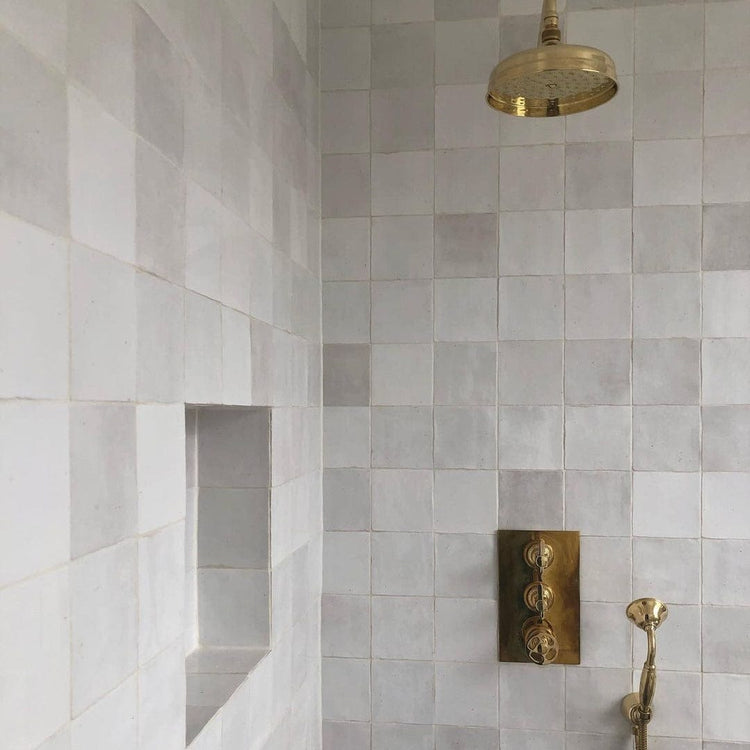 An installed Francone BTS23 wall-mounted hand shower in unlacquered brass, set against neutral tiles by Marble and Ash.