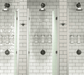 Francone BTS7 wall-mounted bespoke unlacquered brass shower sets  installed in a tiled bathroom.